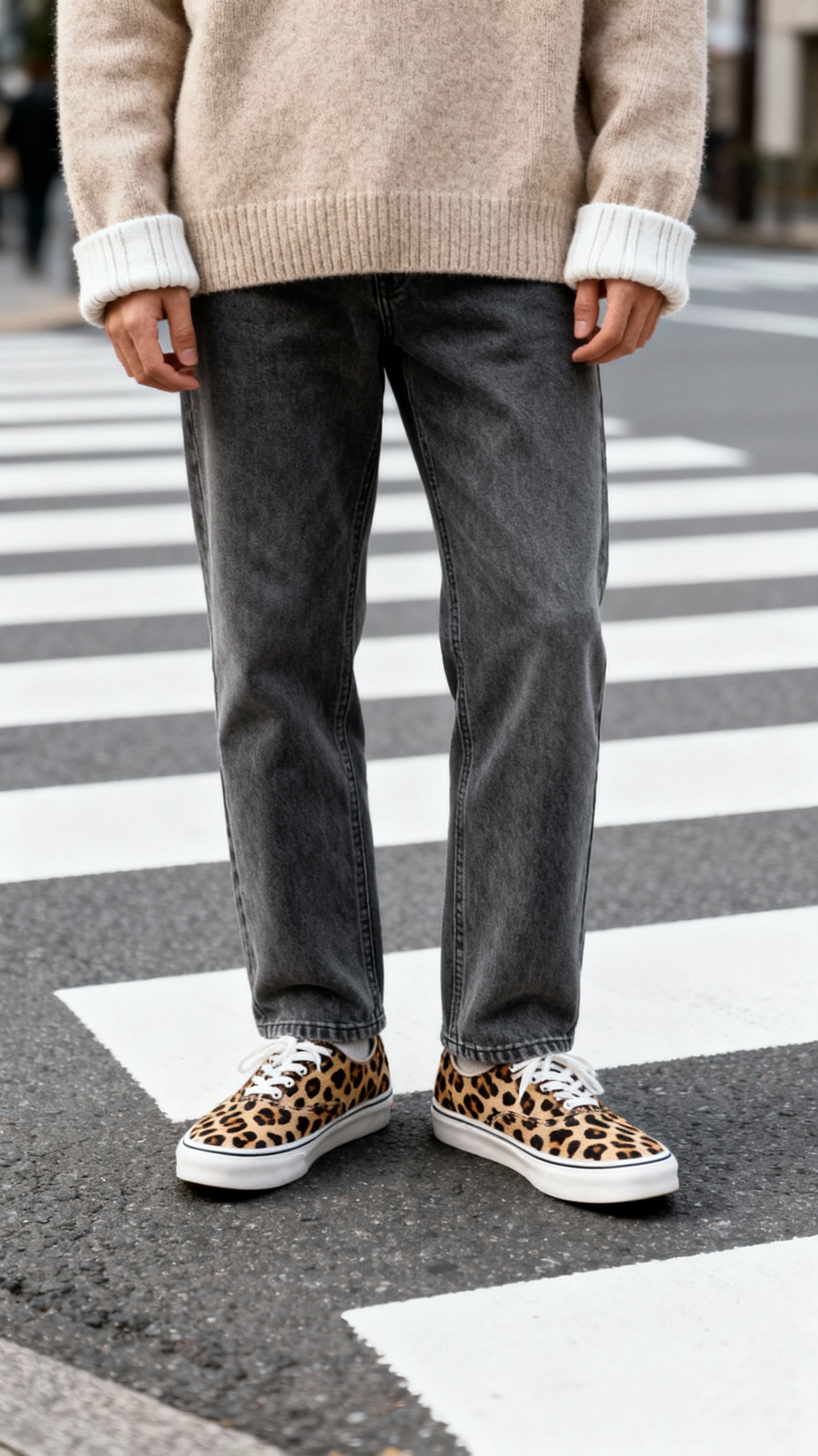 Cheetah sneakers with straight-leg jeans, oatmeal sweater cuffs, city crosswalk