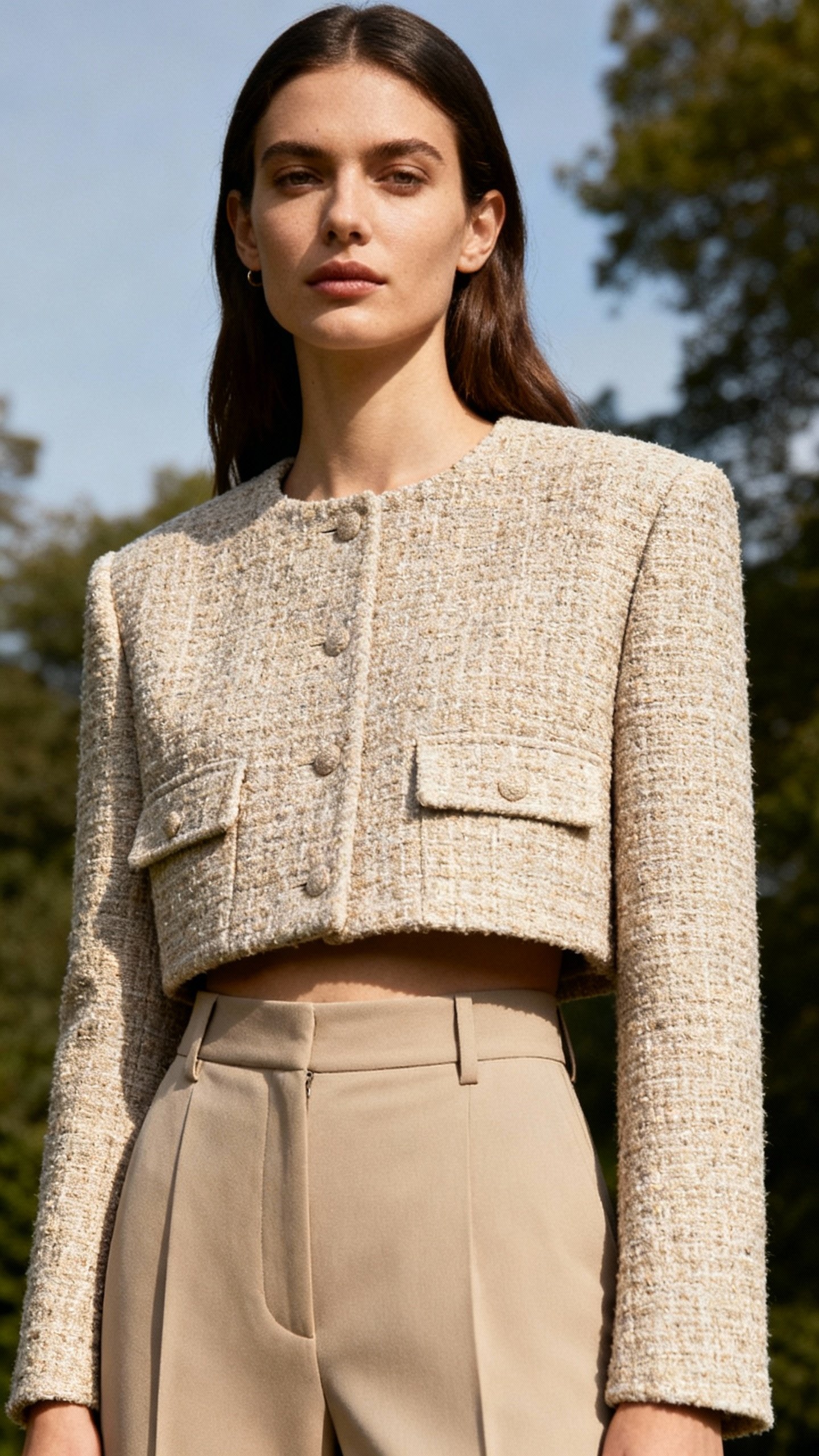 Cropped tweed jacket at high hip over high-rise trousers