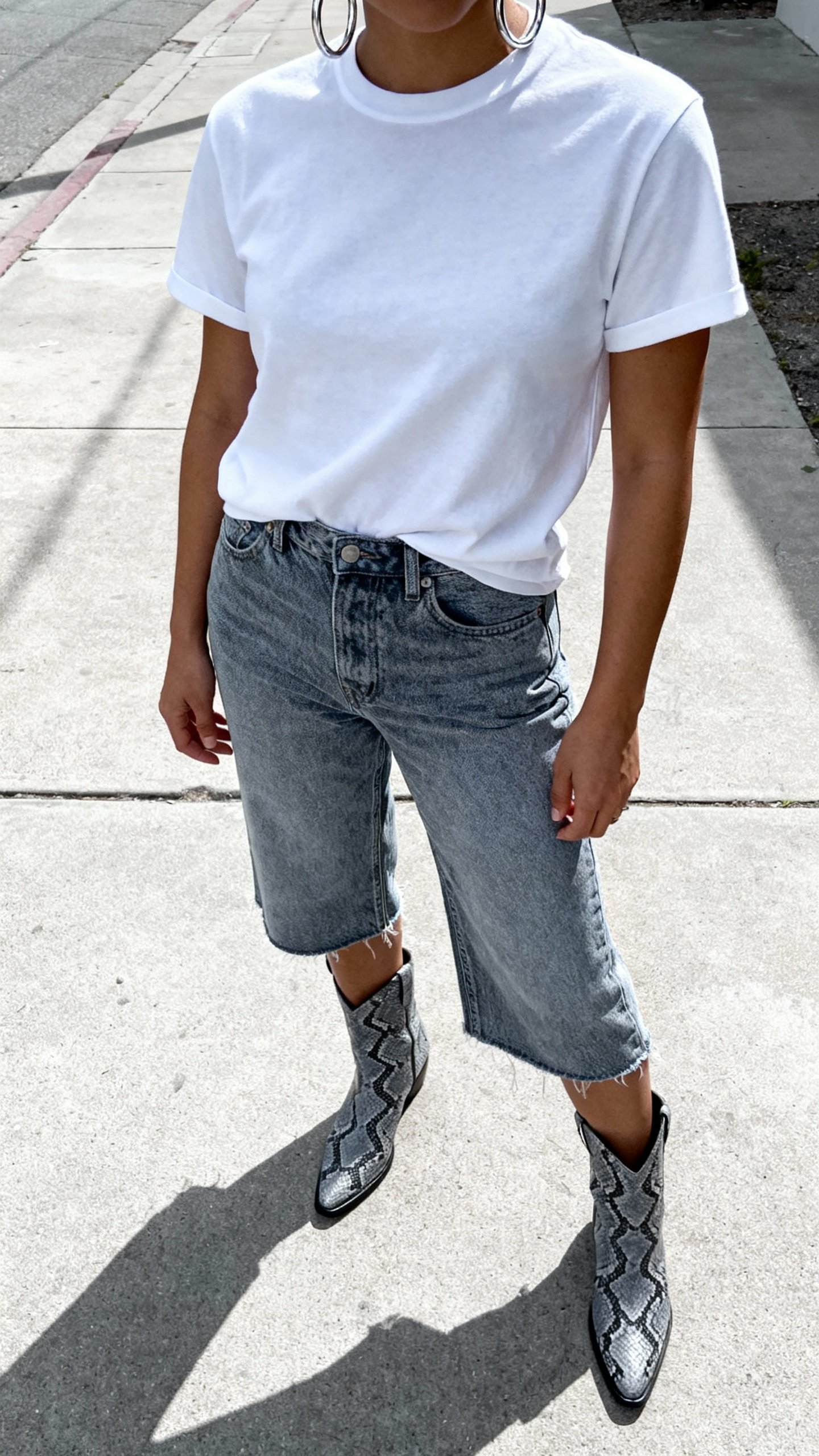 White tee with grey snakeskin boots, cropped denim, silver hoops, sidewalk