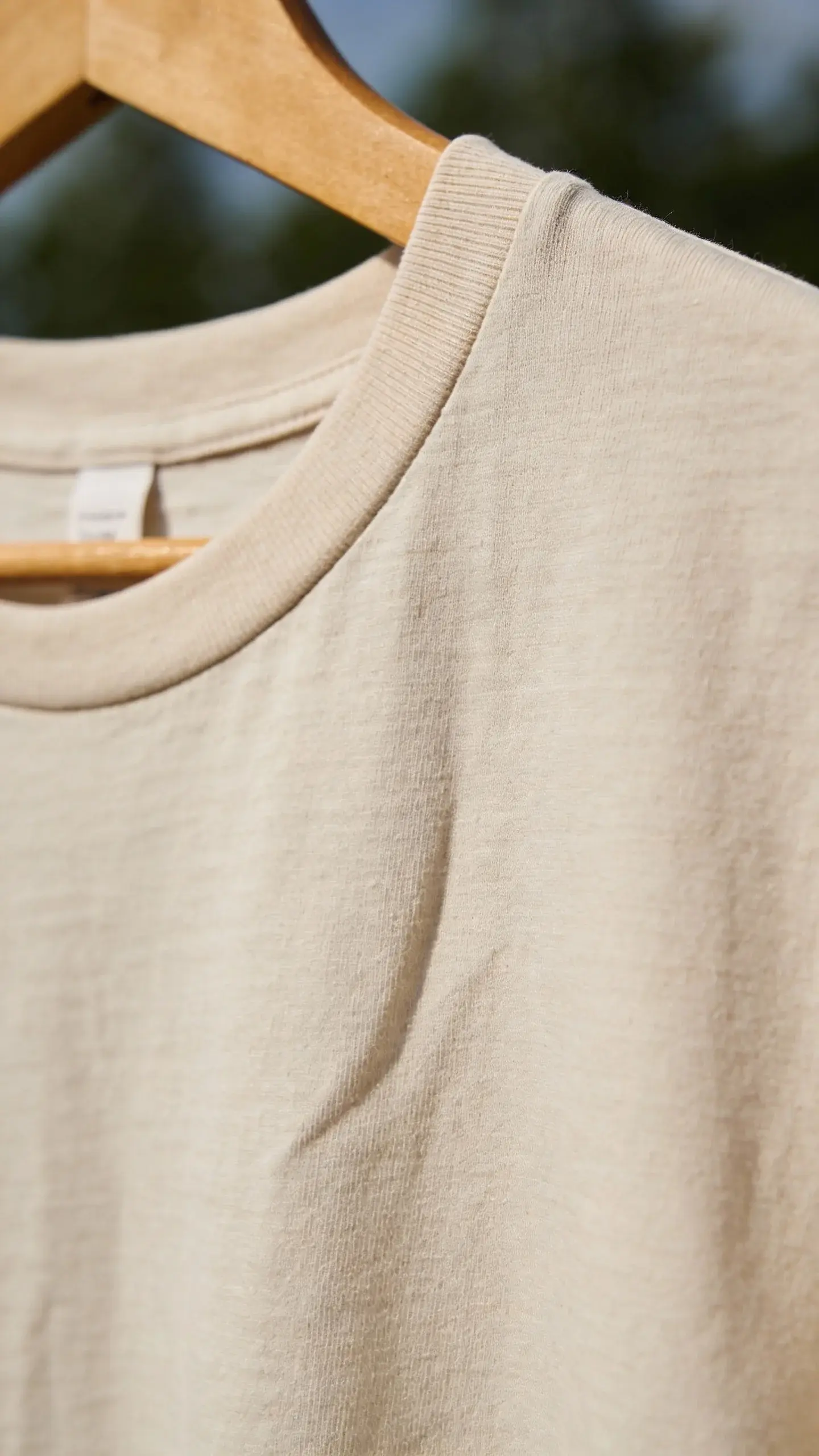 breathable cotton t-shirt on hanger, natural light, close-up fabric