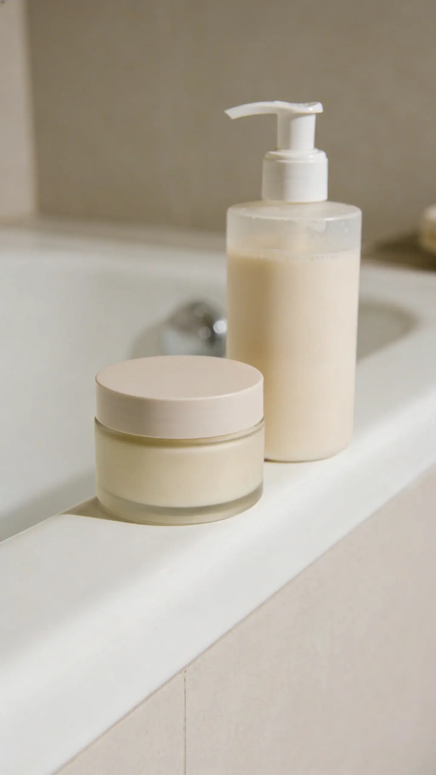 double-cleanse setup: balm jar and cream wash, sink edge