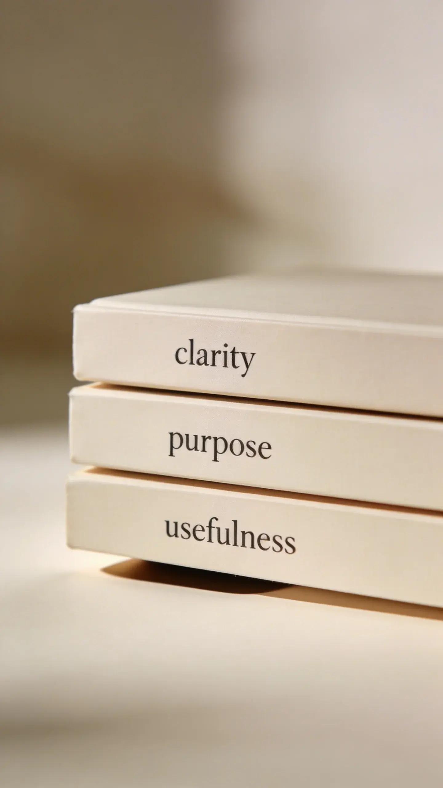 neatly stacked three books labeled clarity purpose usefulness