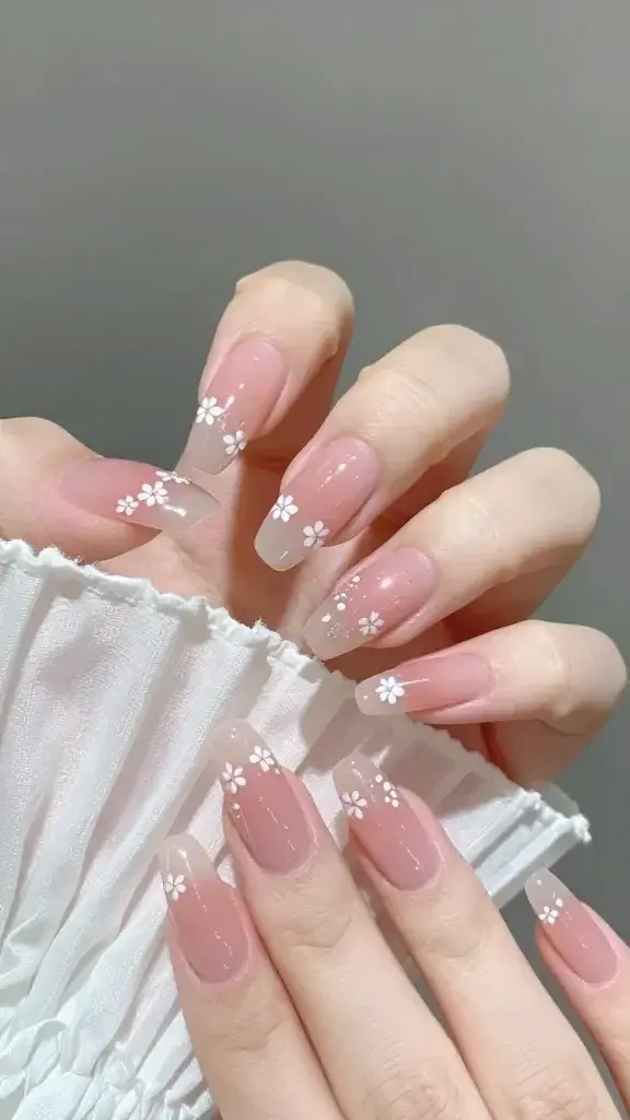 sheer pink almond nails, tiny white floral accents